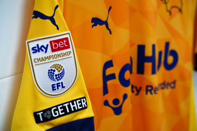 A detailed close-up of the sleeve of the Derby County 2024/25 third shirt showing the Sky Bet Championship and Together patches.
