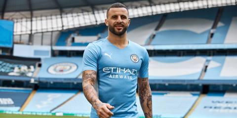 Kyle Walker wears the Manchester City 2021/22 home shirt inside the Etihad Stadium.