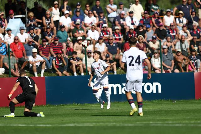 Bologna FC players wearing their white away kit during a match.