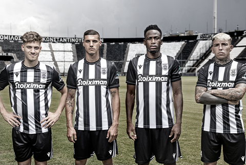 PAOK FC players presenting the new home shirt with classic black and white vertical stripes.