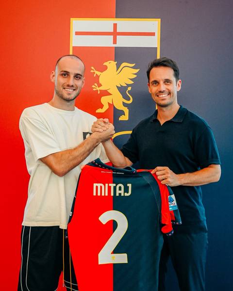 Mario Mitaj holds up his new Genoa CFC home shirt during his presentation