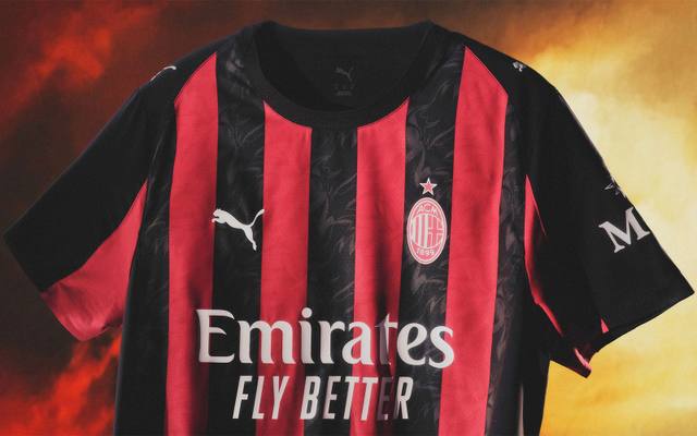 A close-up view of the AC Milan home shirt featuring classic red and black vertical stripes.