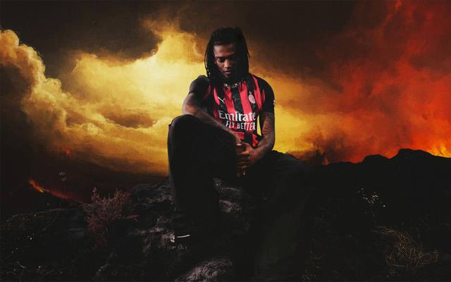 Rafael Leão models the AC Milan 2025/26 home kit in a dramatic campaign image with a smoky red and orange background.