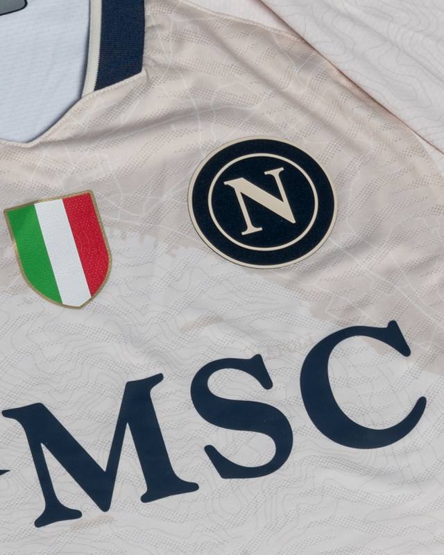 A close-up view of the SSC Napoli 'Everywhere' special edition shirt, showing the club crest, Scudetto shield, and MSC sponsor logo.