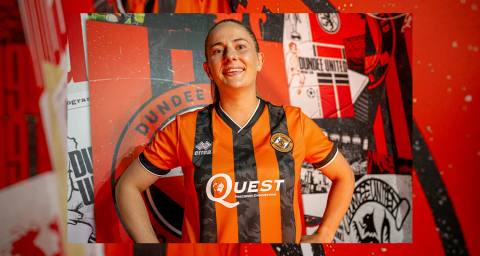 A player posing in the Dundee United home shirt featuring orange and black vertical stripes.