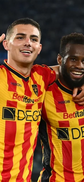 US Lecce players celebrating while wearing the club's red and yellow striped home shirt.