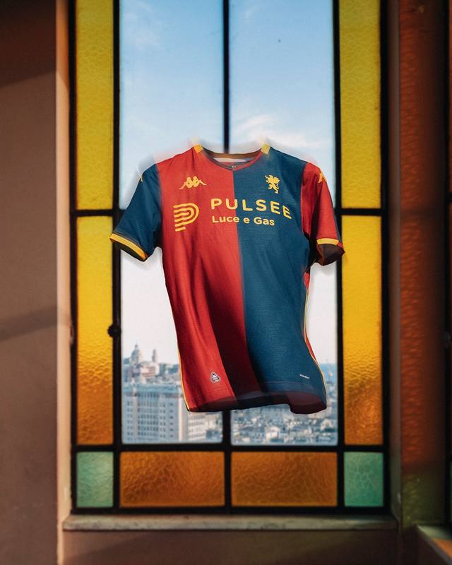 The Genoa CFC home shirt for the 2024/25 season, displayed floating in front of a stained glass window with a city view.
