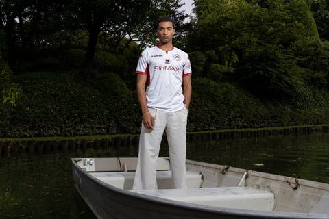 A model standing in a boat wears the white and maroon A.S. Cittadella away shirt.