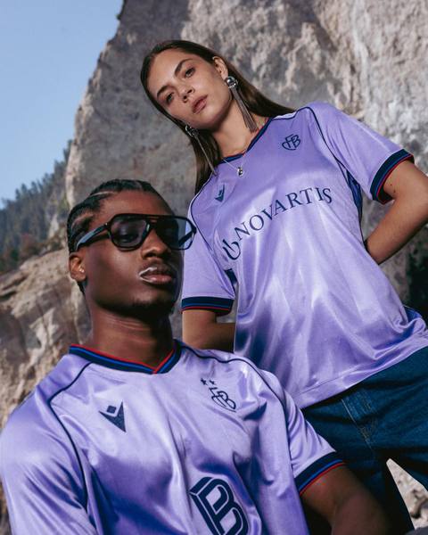 Campaign photo showcasing the lavender FC Basel 1893 2025/26 away shirt worn by two models.