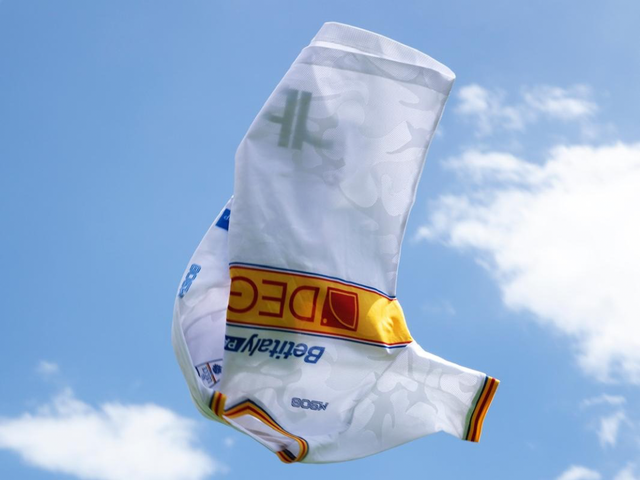 The US Lecce white away shirt shown floating in the air against a blue sky.