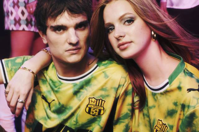 A campaign photo showing models wearing the yellow and green Puma U.S. Sassuolo 2025/26 third shirt.