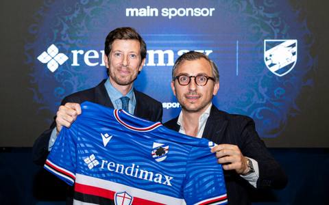 Two men hold up the Sampdoria home shirt during a sponsorship presentation event.