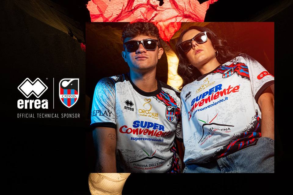 Two models wearing the Catania FC 2023/24 away shirt in an official Erreà campaign graphic.