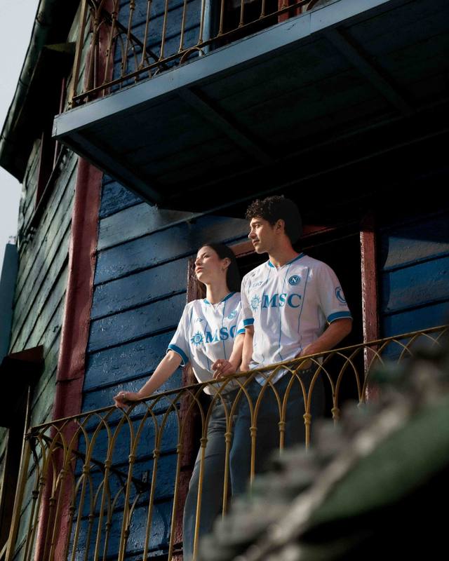 Two models on a balcony wearing the white SSC Napoli 2026/27 away shirt.
