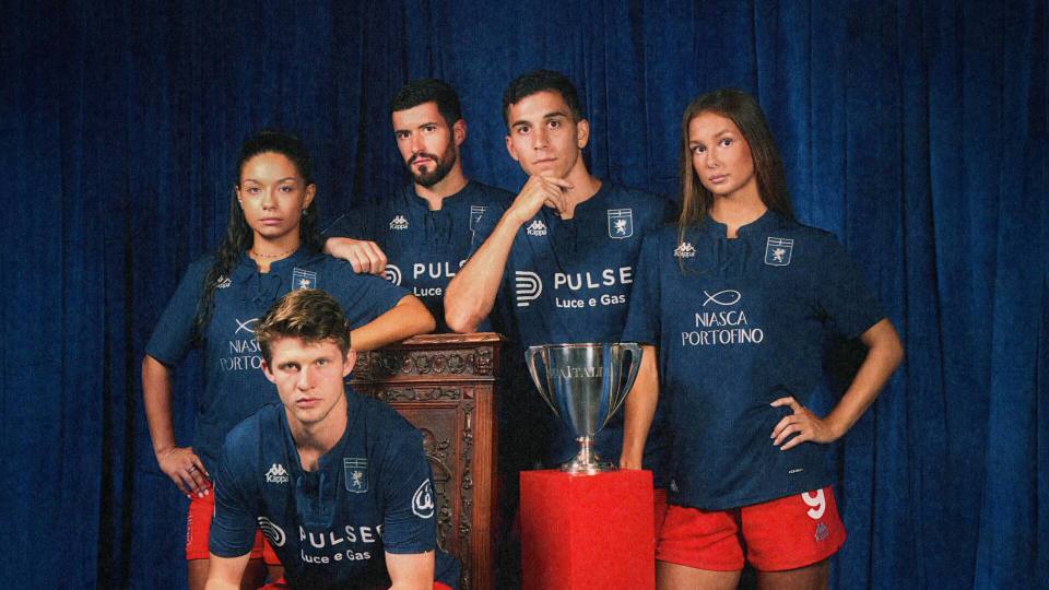 Models wearing the dark blue Genoa CFC third shirt with red shorts in a promotional photoshoot.