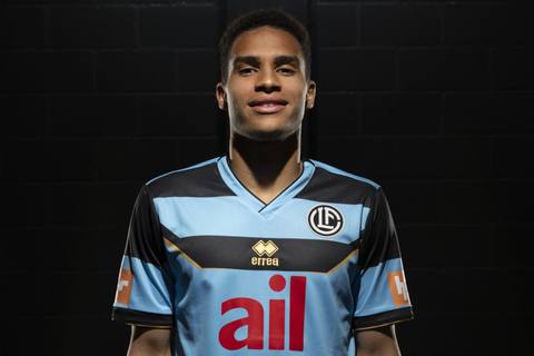 A portrait of a player wearing the FC Lugano 2024/25 third shirt designed by Erreà.
