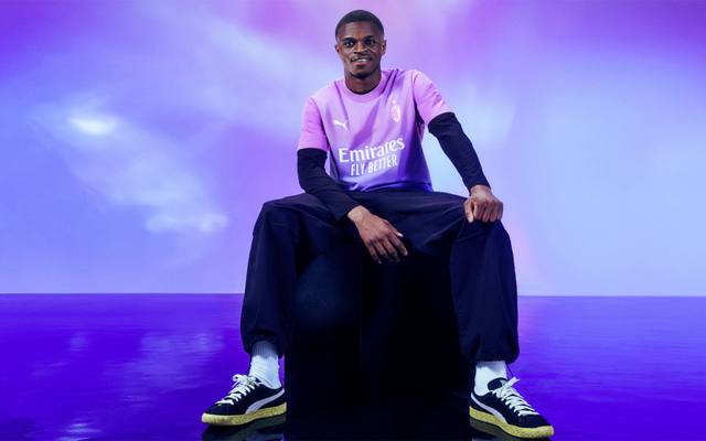 AC Milan player Pierre Kalulu models the pink and purple gradient 2023/24 third shirt.