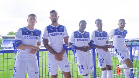 Five AJ Auxerre players present the club's white and blue 2023/24 home shirt.