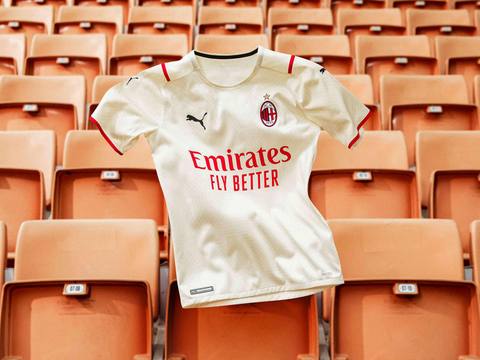 An AC Milan away shirt displayed against orange stadium seating.